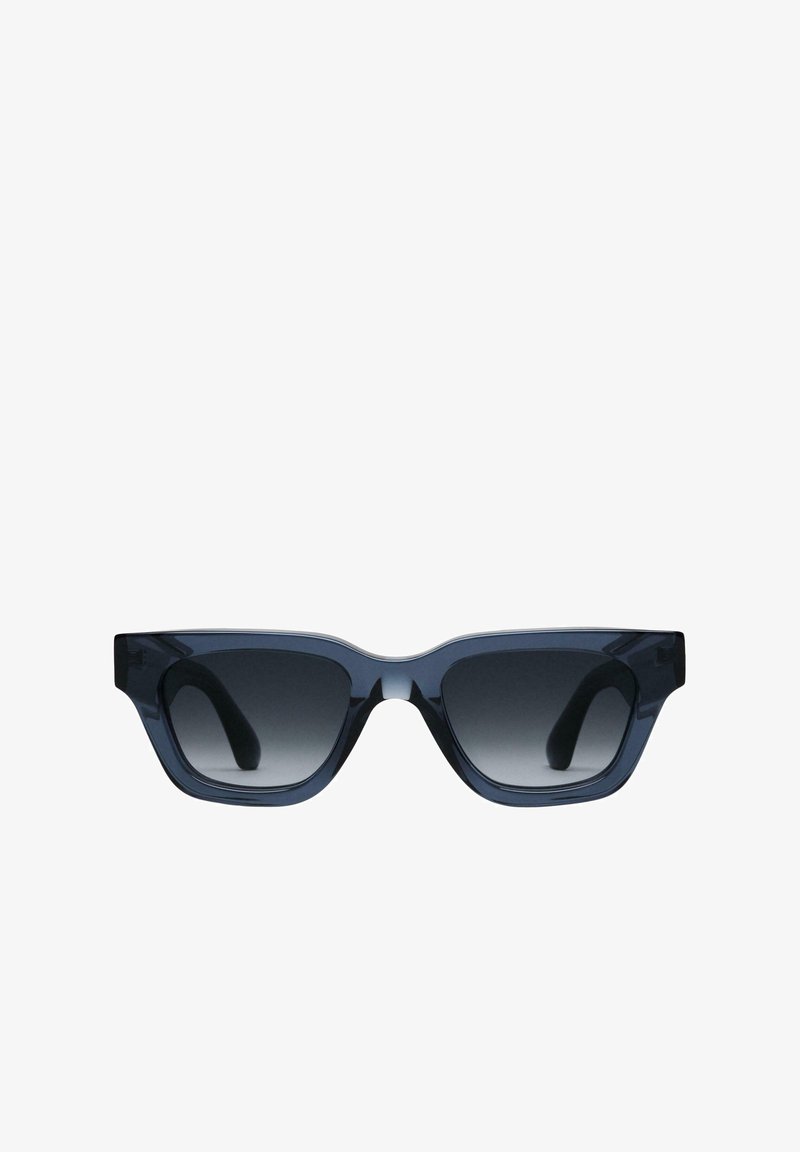 Ochelari de soare supradimensionați, cu un cadru dreptunghiular masiv, în nuanțe de albastru, și lentile întunecate cu gradient. Material plastic neted și temple curbate.