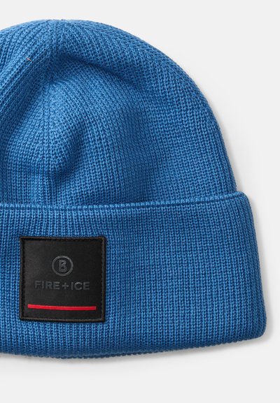 Căciulă tricotată albastră cu o etichetă rectangulară neagră pe care este inscriptionat "FIRE + ICE" și o bandă roșie. Material texturat și design cu margine pliată.