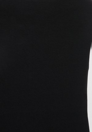 Haut noir sans manches, ajusté, avec texture côtelée sur fond blanc.