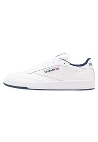 Baskets en cuir blanc avec des accents bleu marine, dotées d'un bout rond, d'un système à lacets et d'une semelle en caoutchouc texturée. Logo Reebok sur le côté.