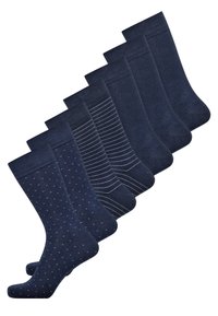 Sæt med syv marineblå sokker med forskellige designs: prikker, striber og ensfarvede mønstre, alle med en glat tekstur og ribbede manchetter.