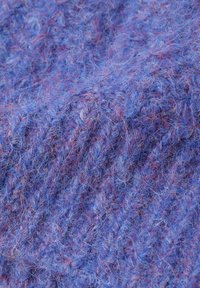 Țesătură tricotată de culoare mov, cu o textură pufoasă, având nuanțe variate de albastru și sugestii de fibre roșii, creând un aspect moale, stratificat.