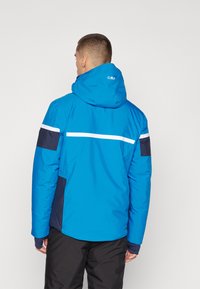 Blaue isolierte Jacke mit Kapuze, mit schwarzen Akzenten und einem weißen horizontalen Streifen über den Rücken und die Arme. Glatte Textur.