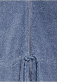 Blue terry cloth zip-up hoodie with a drawstring and textured fabric. Features a vertical zipper and a knotted finishing on the drawstring.