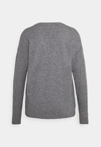 Pull en maille grise avec un col rond, des manches longues et une coupe décontractée. La texture est lisse et le tissu semble léger.