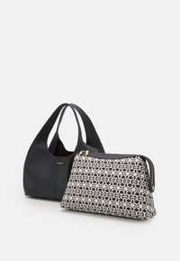 Czarna skórzana torba hobo o zakrzywionym kształcie obok wzorzystej czarno-białej saszetki na zamek, zdobionej geometrycznymi motywami i złotymi akcentami.