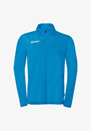 Blauwe jas met volledige ritssluiting, opstaande kraag, lange mouwen, geometrisch patroon op de bovenborst en "Kempa" logo op de linker schouder.
