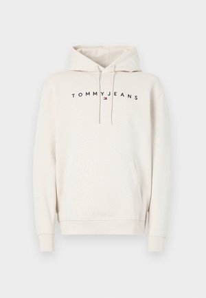 Krémszínű kapucnis pulóver, puha pamutból készült. Elöl kenguru zseb, állítható kapucni és fekete "TOMMYJEANS" logó található a mellen.