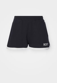 Pantalones cortos deportivos de algodón negro con dobladillo blanco; cuenta con la palabra "ROXY" bordada en blanco. Diseñados para la comodidad y la movilidad.