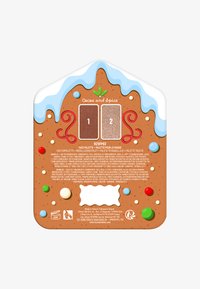 Ansigtspalette med to brune nuancer, brunlig baggrund, der ligner peberkage, hvide glasurdetaljer og farverige sliklignende pynt.