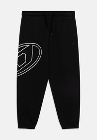 Pantalons de survêtement noirs avec des poignets élastiques, une taille avec cordon de serrage, des poches latérales et un grand design de logo blanc sur la cuisse gauche.