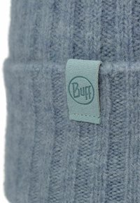 Blue knitted beanie with a ribbed texture and a folded cuff. Features a light blue leather tag with embossed logo.