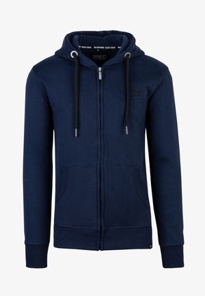 Navy zip-up hoodie made from soft fabric, featuring a drawstring hood, front pockets, ribbed cuffs, and a minimalist logo detail.