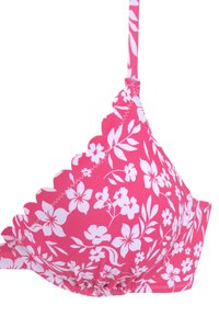 Rosa, mit Blumenmuster versehener BH mit weißen Blumen. Hat gezackte Kanten und verstellbare Träger. Hergestellt aus weichem, dehnbarem Material.