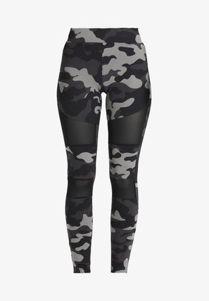 Zwarte en grijze camouflaged leggings met gaasaccenten. Hoog-taille ontwerp, aansluitende pasvorm, soepele textuur en strakke afwerking.