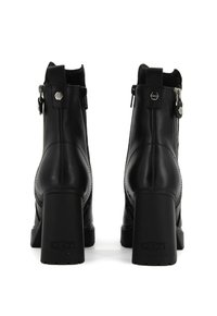 Stivali alla caviglia in pelle nera con tacco a blocco alto, dotati di cerniere laterali, dettagli di cucitura e suola in gomma texturizzata.
