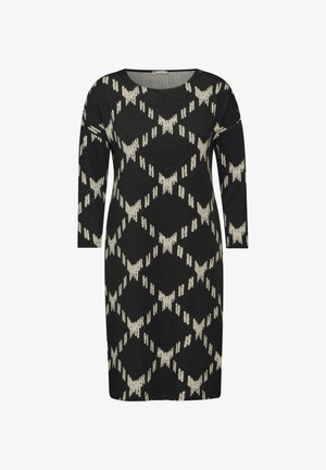 Neulemustrella musta mekko, jossa on kermaisia geometrisia kuvioita, pyöreä kaula-aukko ja pitkät hihat. Pehmeä pinta ja polvipituinen leikkaus.