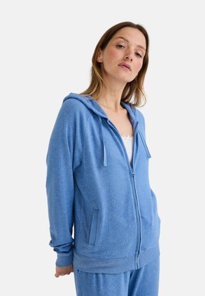 Sweat à capuche zippé bleu avec deux poches avant, cordon de serrage pour la capuche et poignets côtelés. Fabriqué en tissu doux et texturé avec un motif chiné.