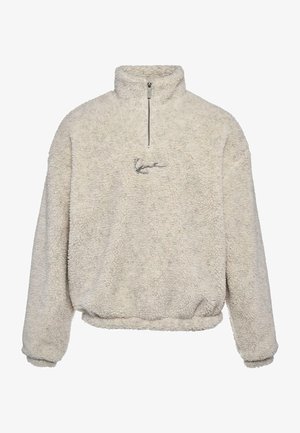 Kreemivärvi pullover, mis on valmistatud tekstuurilisest fliisist, millel on pool tõmblukk ja väike brodeeritud logo ees.