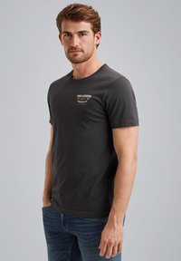Dark gray cotton t-shirt with short sleeves, featuring white and gold graphic text on the chest. Fitted design with a crew neckline.