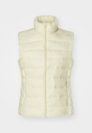 Light yellow puffer vest with high collar, vertical quilted design, front zipper closure, and no sleeves. Smooth texture and minimalistic style.