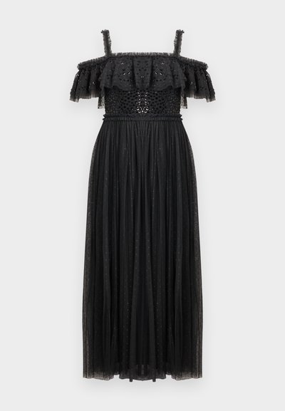 Robe maxi noire à épaules dénudées, avec un décolleté à volants en étages, un corsage ajusté orné de sequins, et une jupe fluide en transparent à pois.
