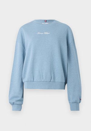 Svijetloplavi dukserica s okruglim izrezom, s rebrastim manžetama i porubom, s natpisom "Tommy Hilfiger" izvezenim u bijelo na prednjem dijelu. Mekana tkanina.