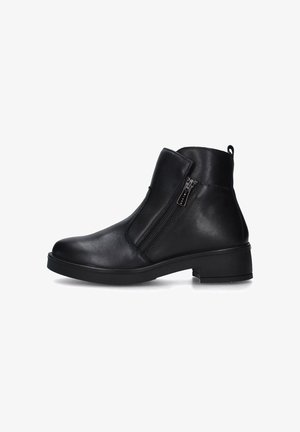 Bottine en cuir noir avec fermeture éclair latérale, talon bloc bas, bout arrondi et languette à l'arrière, vue de profil sur fond blanc.