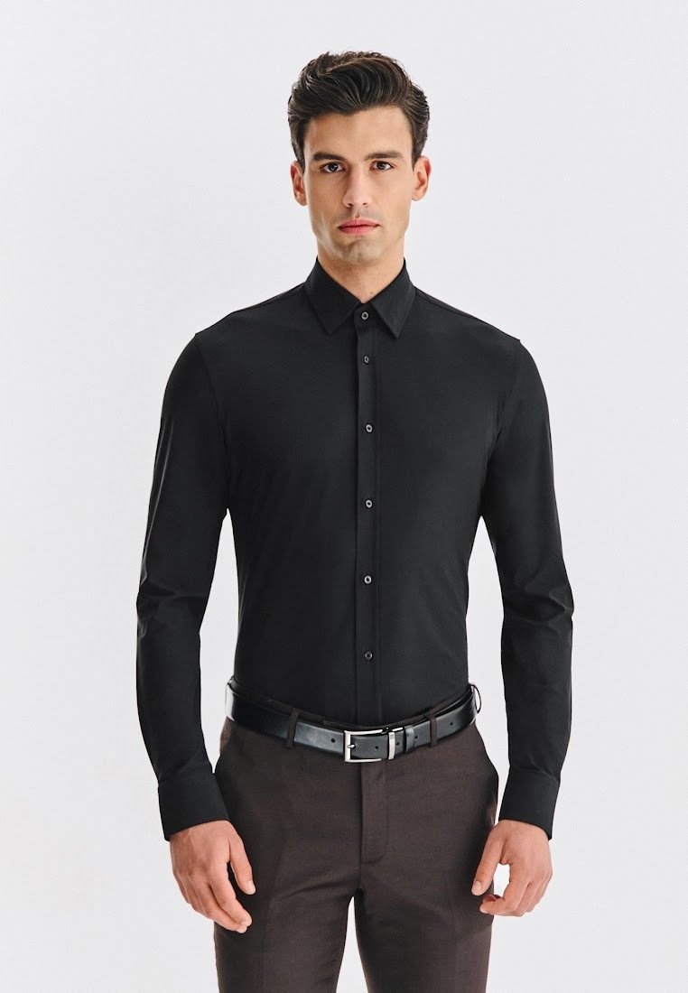 Czarna koszula z długim rękawem, zapinana na guziki, z klasycznym kołnierzykiem, o dopasowanym kroju i gładkiej tkaninie, w zestawie z ciemnymi spodniami i czarnym paskiem.