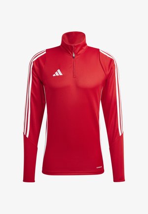 Punane sportlik pikkade varrukatega topp, millel on veerandzip, valged kolm triipu käistelt ja kehaehe disain. Valmistatud siledast ja hingavast materjalist.