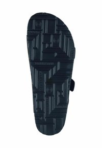 Black rubber shoe sole with a textured surface, featuring a tread pattern of squares and ridges for grip and durability.