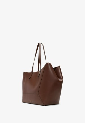Brown large leather tote bag with dual handles and geometric side panels, featuring a small gold logo on the front.
