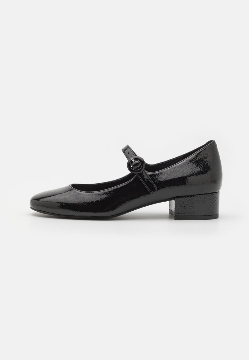 Black patent leather Mary Jane shoe with a round toe, small block heel, and a strap with a circular buckle detail. Smooth, shiny texture.