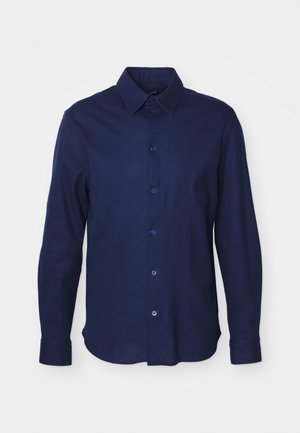 Langarm overhemd in donker marineblauw, gemaakt van zachte stof. Kenmerkt zich door een klassieke kraag, knoopsluiting aan de voorkant en een ronde zoom.