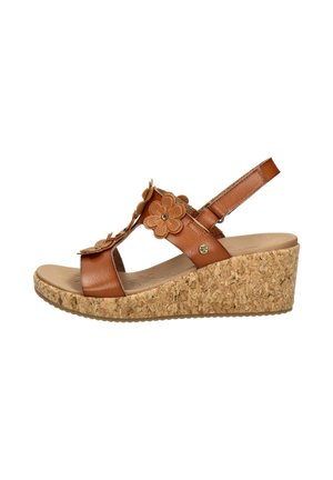 Brauner Ledersandale mit Keilabsatz, Korksohle, floralen Ausschnittverzierungen und verstellbarem Knöchelriemen.