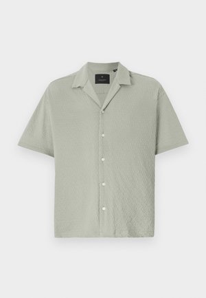 Short-sleeve button-up shirt in light green, textured fabric with a diamond pattern, featuring a notched collar and front button closure.
