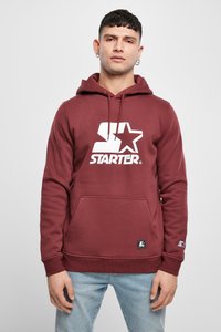 Felpa cappuccio bordeaux realizzata in misto cotone con tessuto testurizzato. Presenta un grande logo bianco "STARTER" e una tasca frontale. Include polsini e orlo a costine.