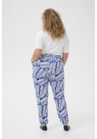 Comfortable, elastic-waist pants with a blue and white leaf pattern, tapered fit, and lightweight fabric, designed for ease of movement.