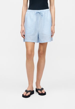 Person wearing light blue and white checkered shorts with a drawstring waist, black sleeveless top, and black platform sandals.