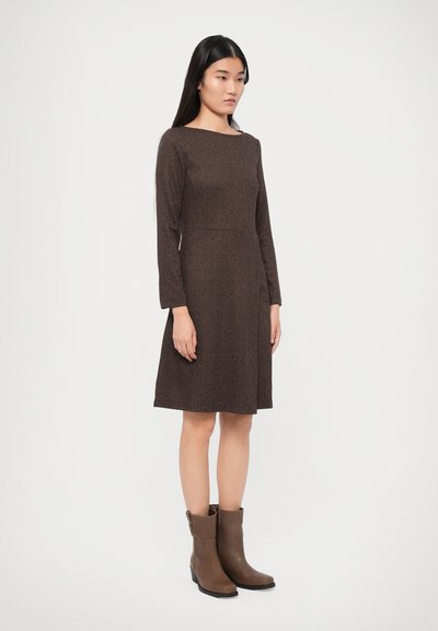 Brown long-sleeve dress with a fitted bodice and flared skirt, featuring a textured pattern. Paired with brown ankle boots.