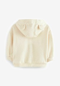 Haut en beige clair avec une texture mouchetée, dotée d'une capuche arrondie avec de petites oreilles, des poignets élastiques et un ourlet. Matière en mélange de coton doux.