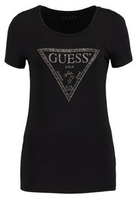 Schwarzes T-Shirt mit kurzen Ärmeln und Rundhalsausschnitt, das auf der Vorderseite ein dreieckiges Logo-Design aus silbernen Strasssteinen aufweist. Weicher Stoff mit taillierter Passform.