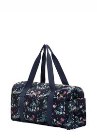 Floral pattern duffel bag with navy base, quilted texture, sturdy handles, and a side pocket for additional storage.