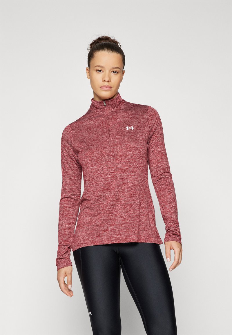 Rød langærmet atletisk top med kvart-zip halsudskæring, struktureret stof og et lille hvidt logo på brystet, parret med sorte leggings.