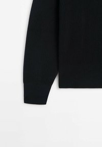 Black ribbed sweater cuff with a textured finish. Features a straight edge and a snug fit. Fabric appears soft and stretchy.
