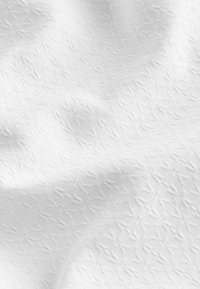 White fabric with a textured pattern featuring small, diamond-like shapes. Soft, subtle sheen with a smooth, woven surface.
