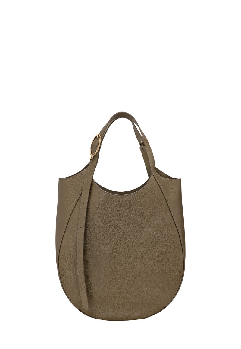 Brown leather tote bag with rounded bottom, adjustable strap, and gold-tone buckle detail, set against a white background.