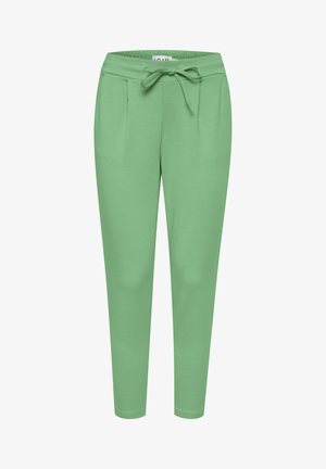 Pantalons de jogging vert clair en tissu doux, dotés d'une taille avec cordon de serrage, de deux poches avant et d'une coupe fuselée.