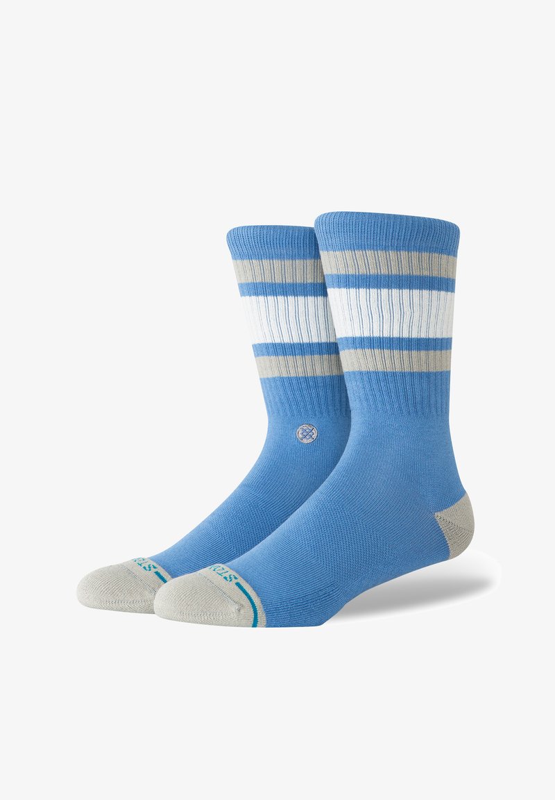 Chaussettes bleues avec des rayures horizontales bleu clair et beige. Dotées de poignets côtelés et d'un renfort à l'orteil. Tissu doux avec une texture lisse.