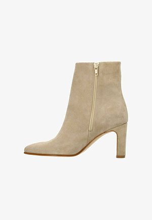 Beige suède enkellaars met een spitse neus, zijrits en een blokhak van 7,5 cm. Gladde textuur en minimalistisch ontwerp.